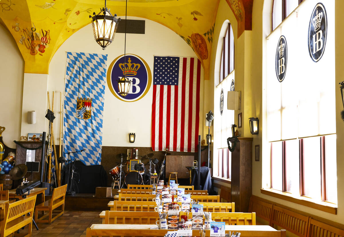 A giant Bavarian flag, left, and U.S. flag are displayed at Hofbräuhaus Las Vegas, on Thur ...
