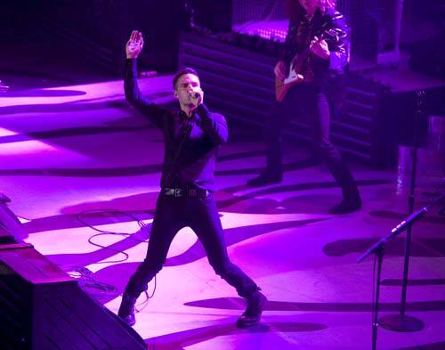 Brandon Flowers of The Killers performs with the band to a sold-out crowd during the opening ni ...