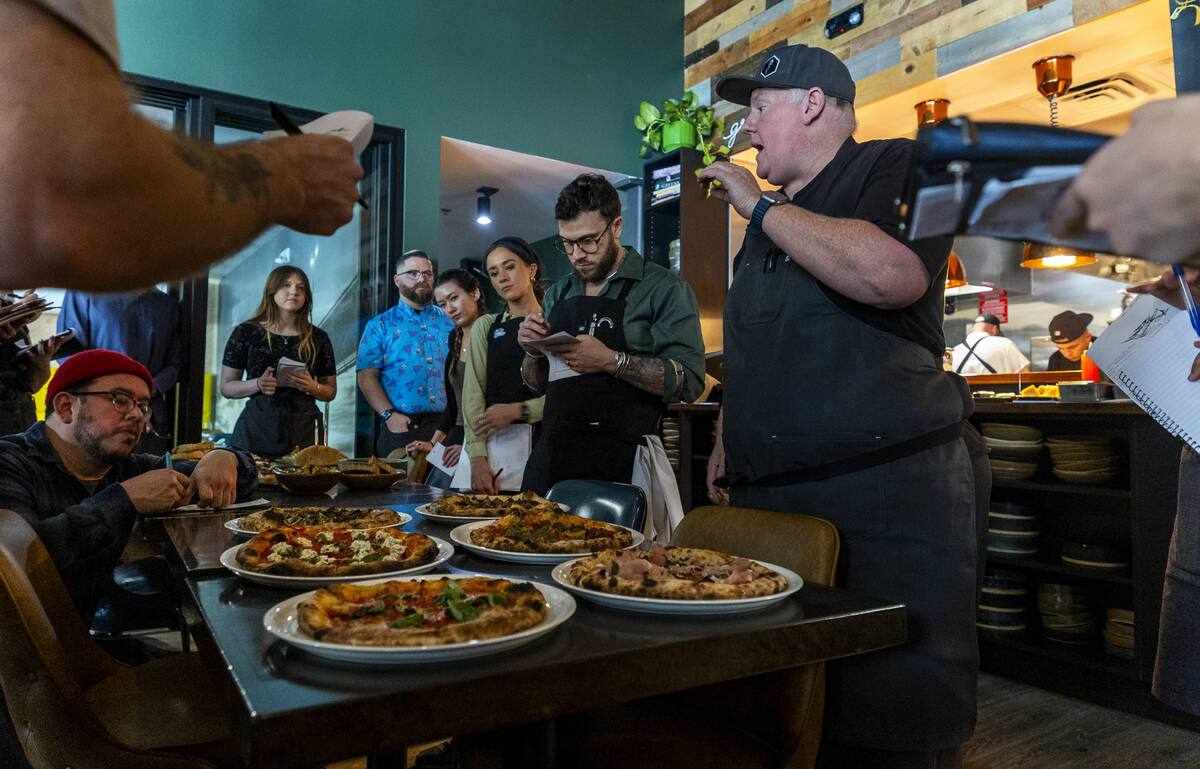 Esther's Kitchen chef/owner James Trees talks with his staff about each of their wood-fire oven ...