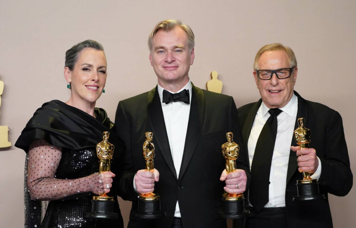 Emma Thomas, from left, Christopher Nolan, and Charles Roven pose in the press room with the aw ...