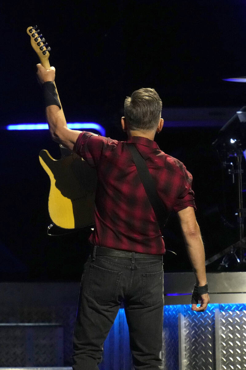 Bruce Springsteen acknowledges the crowd behind him during his concert of Bruce Springsteen and ...