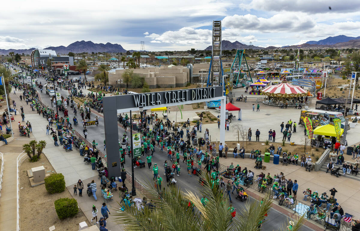 Participants make their way on the parade route down Water Street during the St. Patrick&#x2019 ...