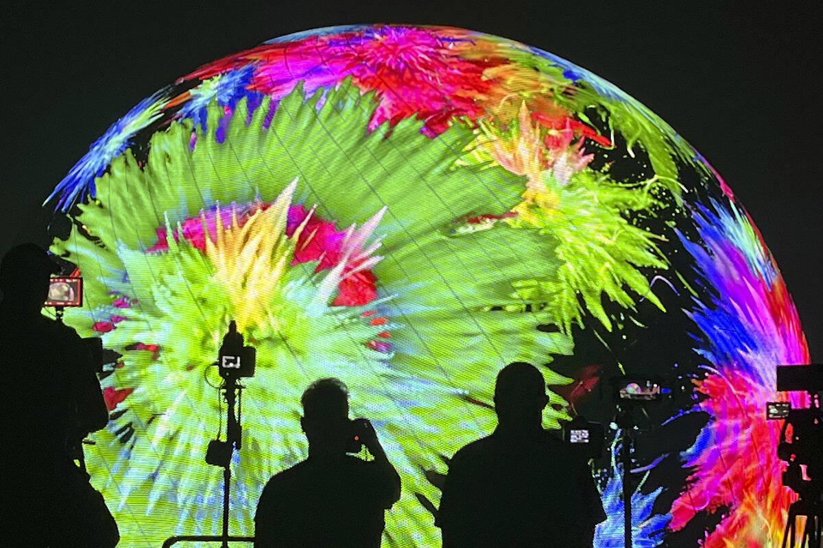 People watch and film the MSG Sphere July 4th fireworks show on Tuesday, July 4, 2023, in Las V ...