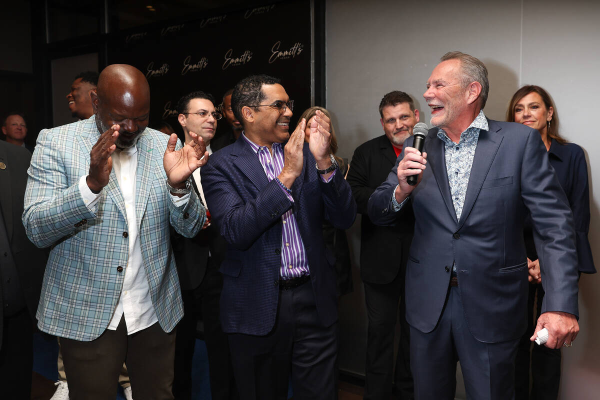 NFL legend Emmett Smith, left, is congratulated on his new restaurant during an opening night p ...