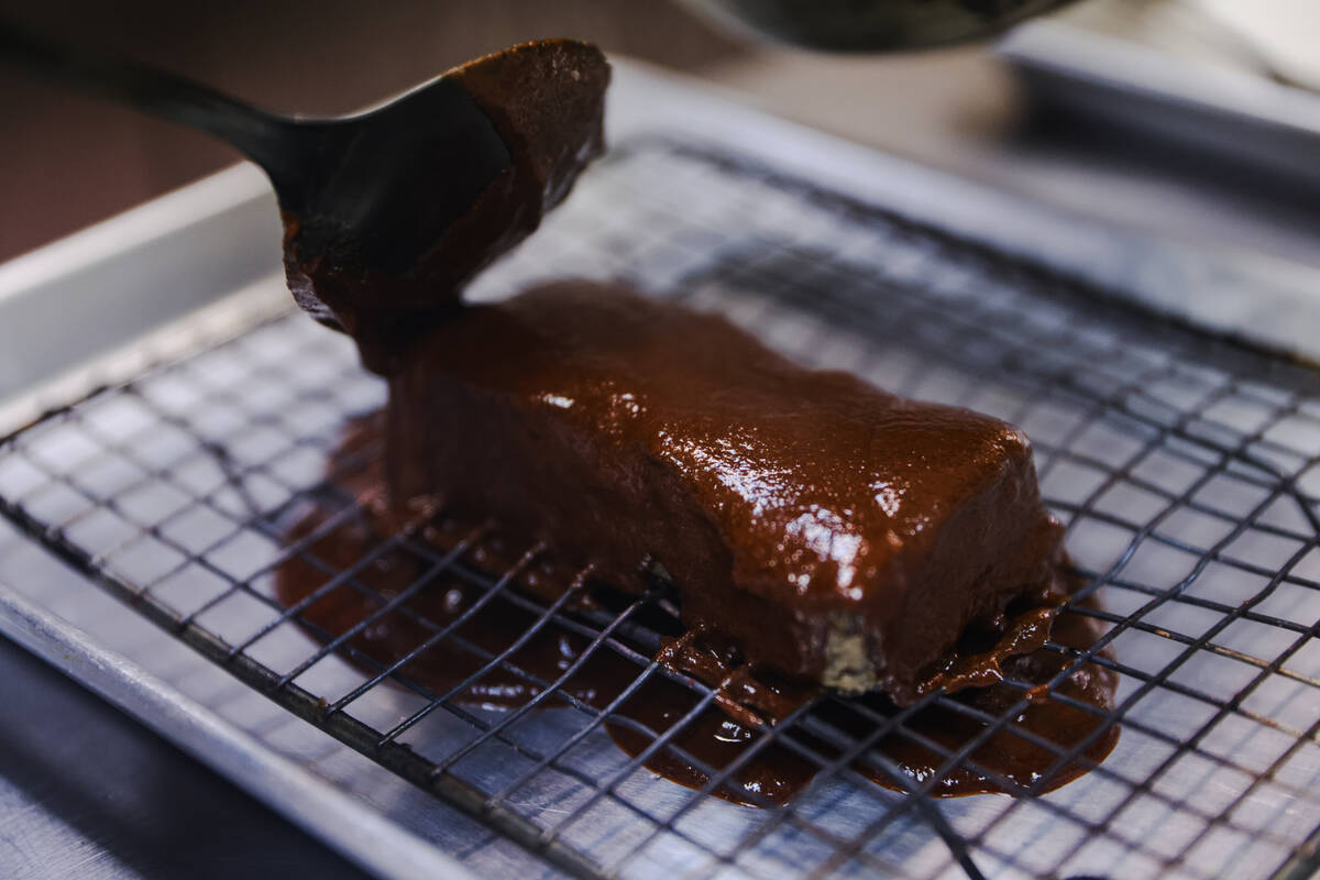 Chef and owner Steve Kestler prepares beef short ribs with mole, roasted sweet potatoes and esq ...
