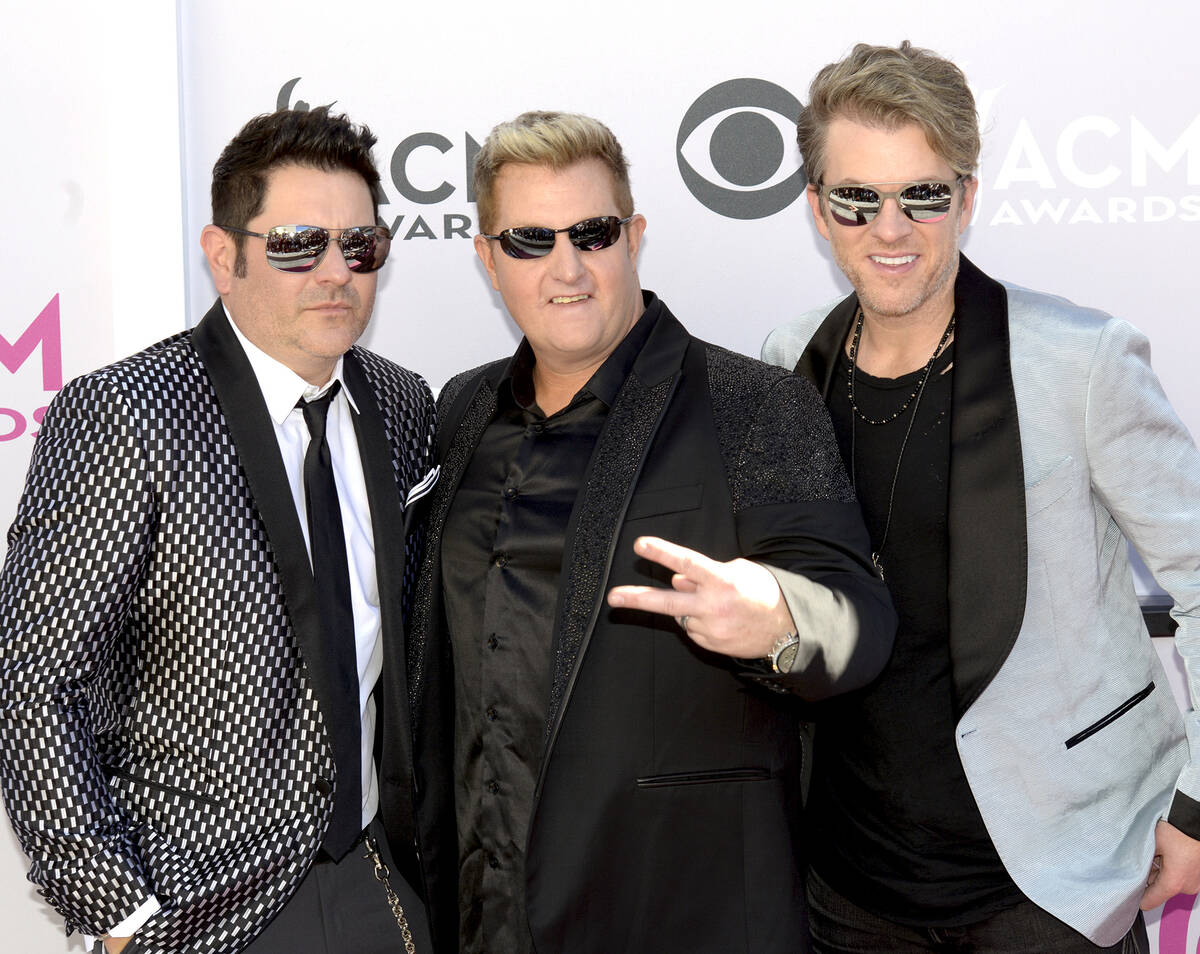 Jay DeMarcus, Gary LeVox and Joe Don Rooney of Rascal Flatts walk The Academy of Country Music ...