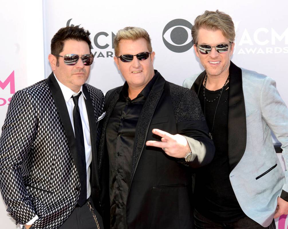 Jay DeMarcus, Gary LeVox and Joe Don Rooney of Rascal Flatts walk The Academy of Country Music ...