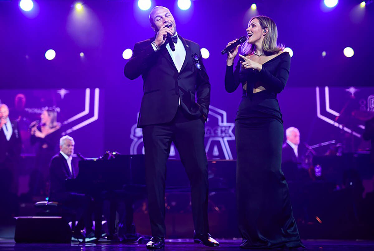 Raiders coach Antonio Pierce, left, and Katharine McPhee duet on "My Girl" at the inaugural Rai ...