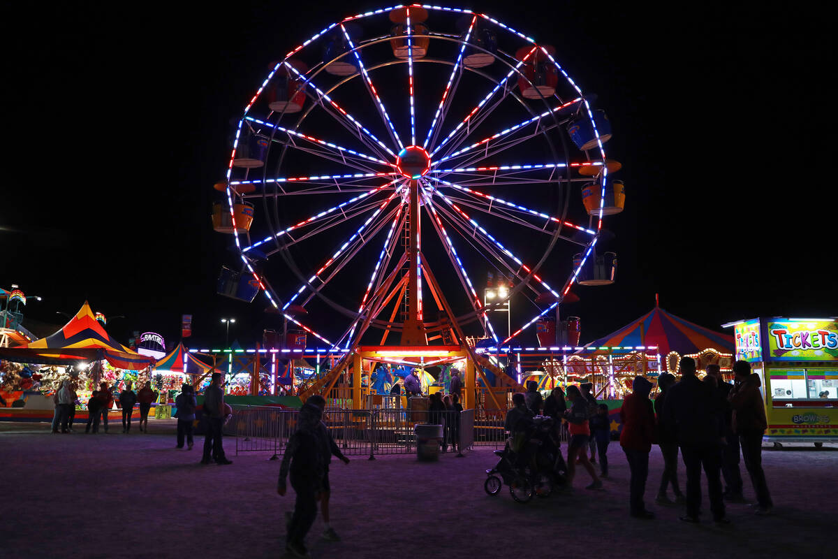 Attendees walk around the Clark County Fair & Rodeo in Logandale, Thursday, April 12, 2018. And ...
