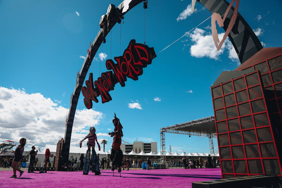 Performers on stilts greet festival goers during the Sick New World music festival at the Las V ...