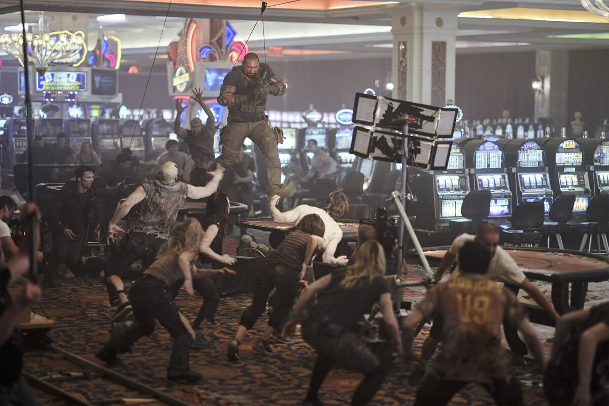 Dave Bautista battles a casino filled with zombies while filming a scene from “Army of th ...