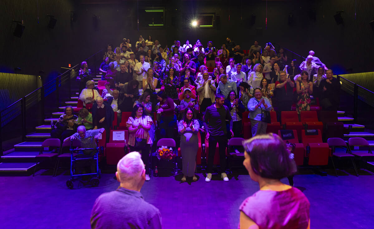The audience gives a standing ovation following the discussion between Jennifer Lin, right, who ...
