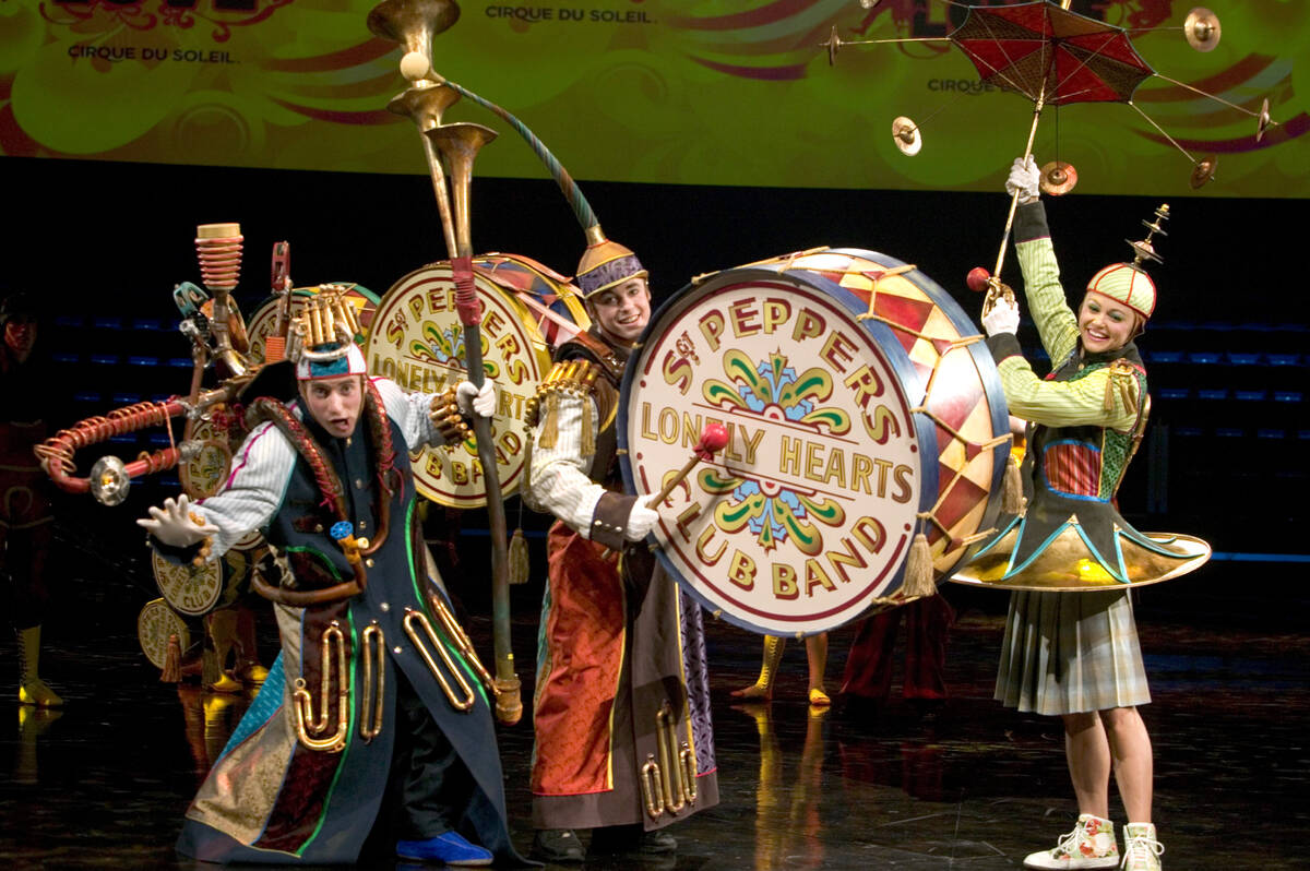 Cast members of Cirque du Soleil's LOVE poise for photographs during a media preview of the sho ...