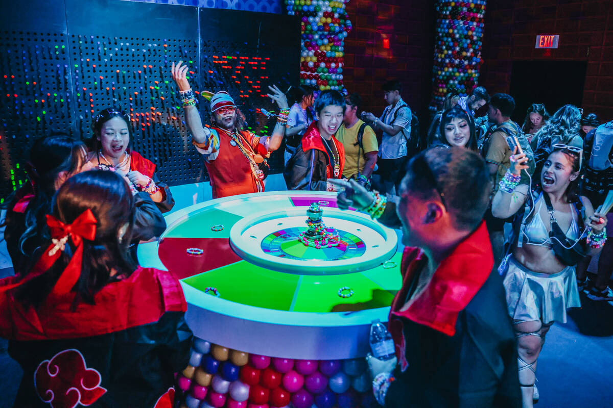 EDC attendees play a game during day one of Electric Daisy Carnival at the Las Vegas Motor Spee ...