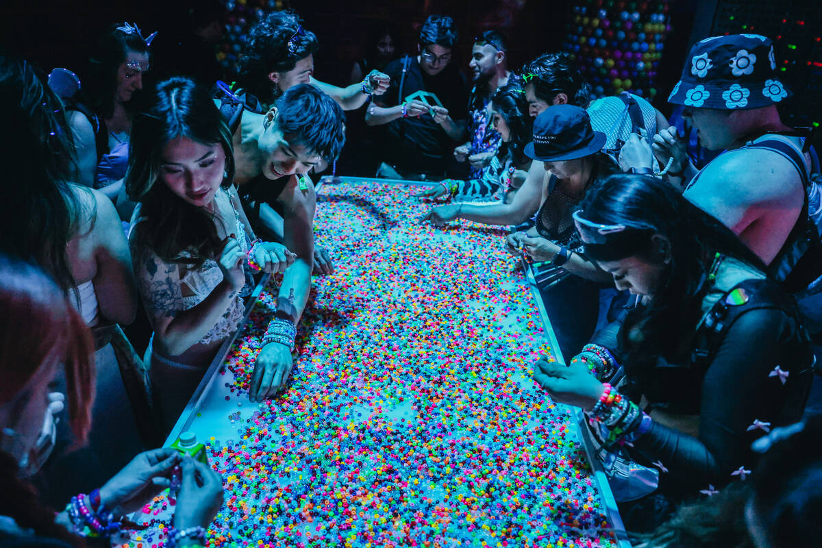 EDC attendees make kandi bracelets during day one of Electric Daisy Carnival at the Las Vegas M ...