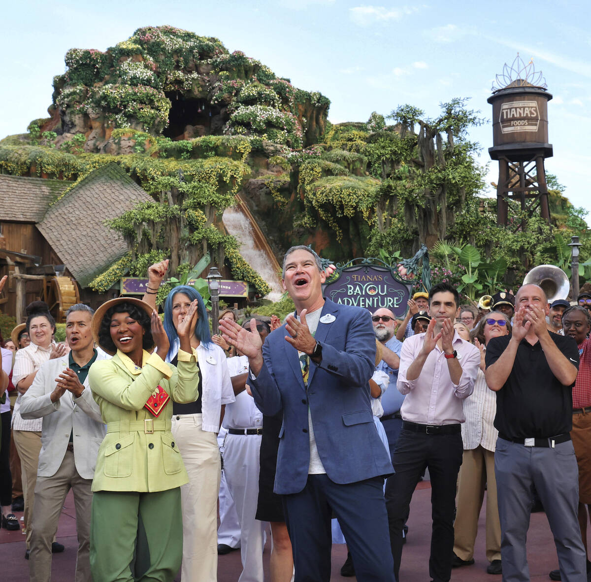With Princess Tiana, Walt Disney World president Jeff Vahle cheers employees during a "Thank Yo ...