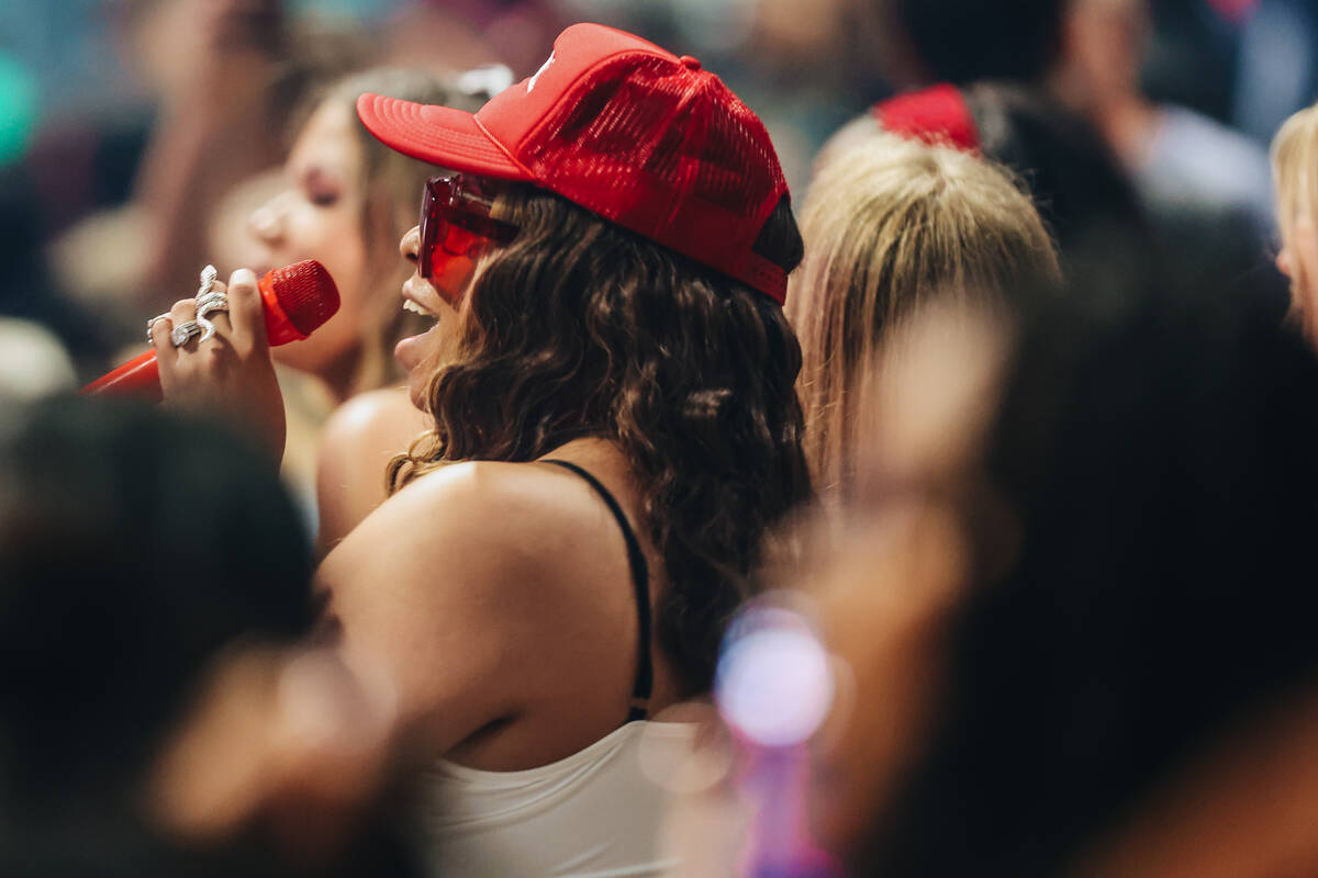 A fan sings into a microphone that she brought with her during the Hot girl Summer Tour at MGM ...