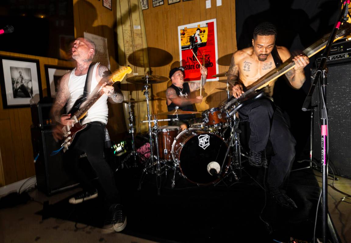 Tim Stewart, left, and Jonny Goood, of Damnage, right, perform with Branden Steineckert, of Ran ...