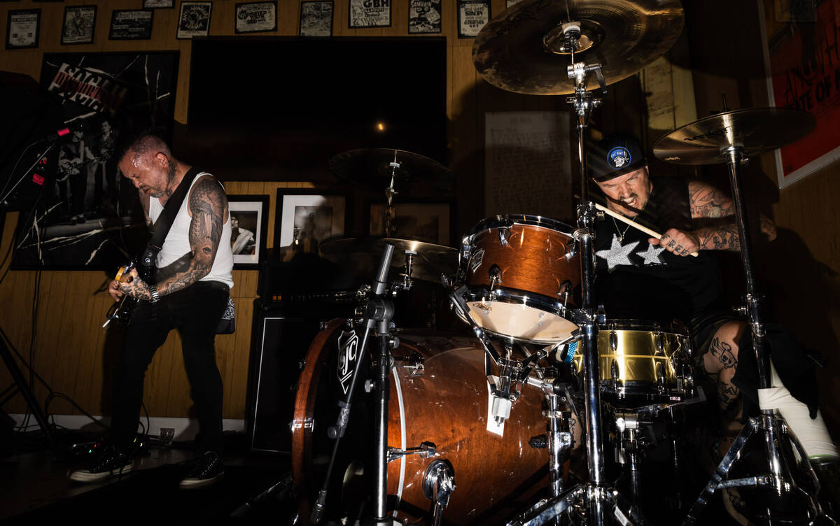 Tim Stewart, left, and Jonny Goood, of Damnage, right, perform with Branden Steineckert, of Ran ...