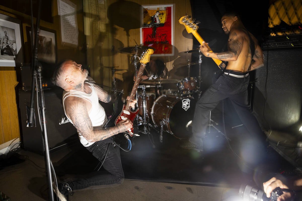 Tim Stewart, left, and Jonny Goood, of Damnage, right, perform with Branden Steineckert, of Ran ...