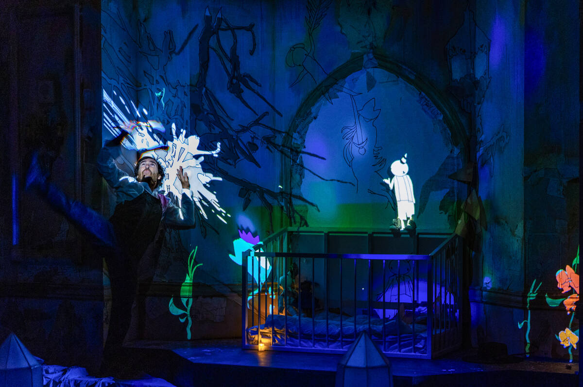 A performer crashes into the wall as animated characters move about during a scene at Particle ...