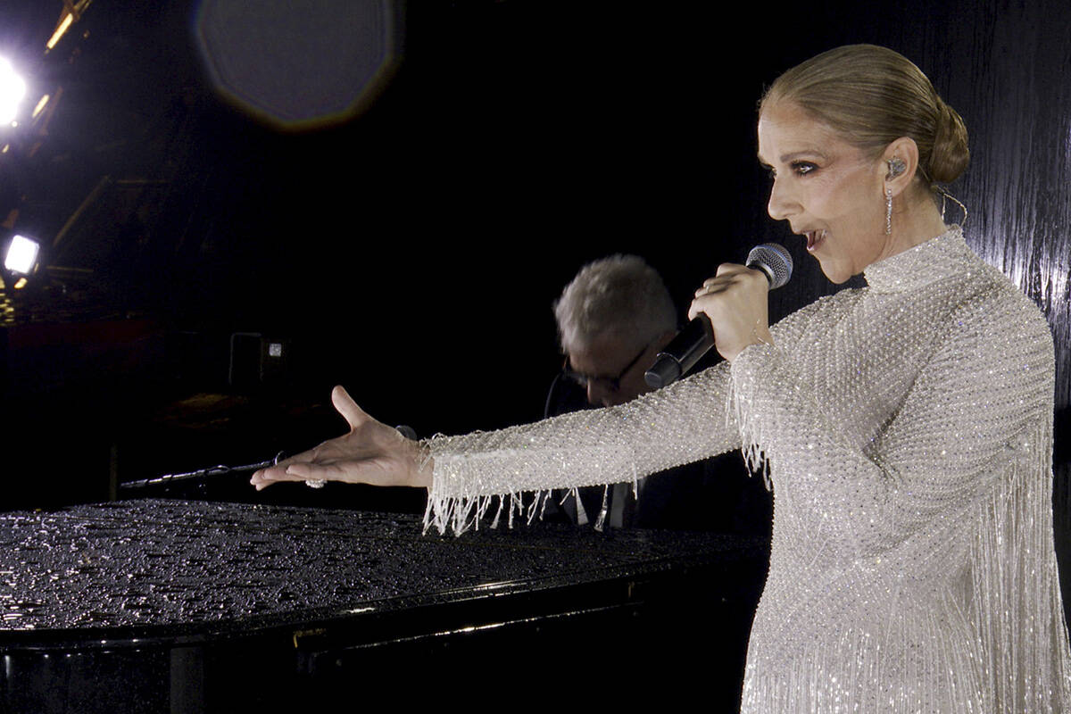 This photo released by the Olympic Broadcasting Services shows Canadian Singer Celine Dion perf ...