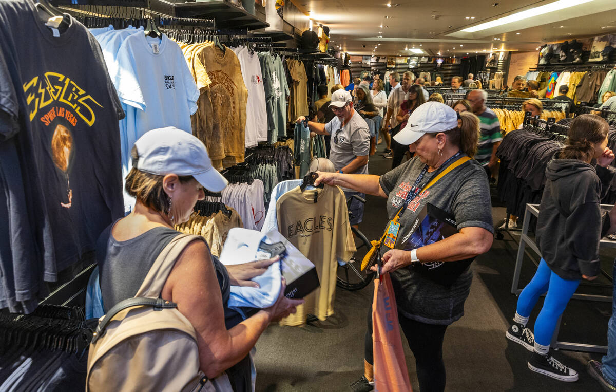 Fans check out items for sale in the merchandise area within the Eagles exclusive fan experien ...