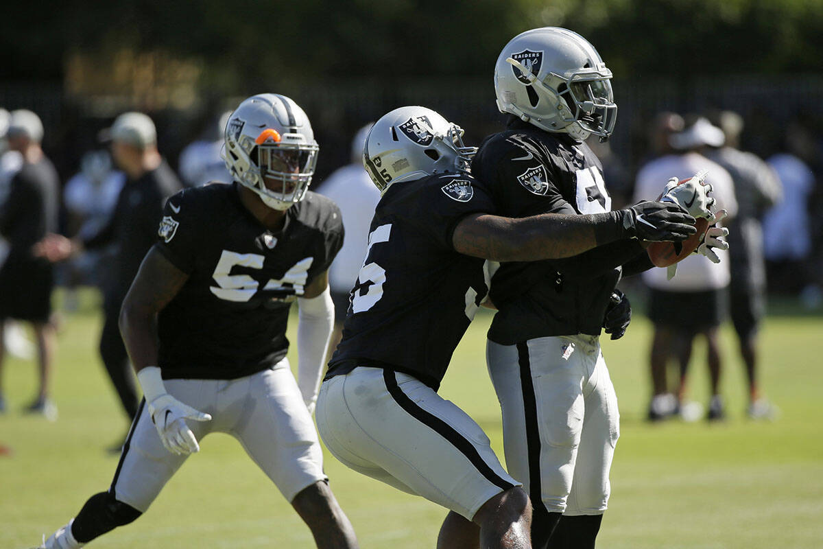 From left, Oakland Raiders linebackers Brandon Marshall, Vontaze Burfict and Te'Von Coney take ...