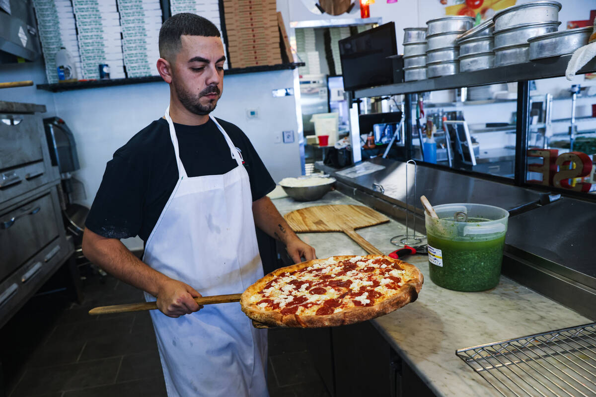 Owner Joey Scolaro prepares the Upside Down Pizza at Lucino’s pizza in Las Vegas, Thursd ...