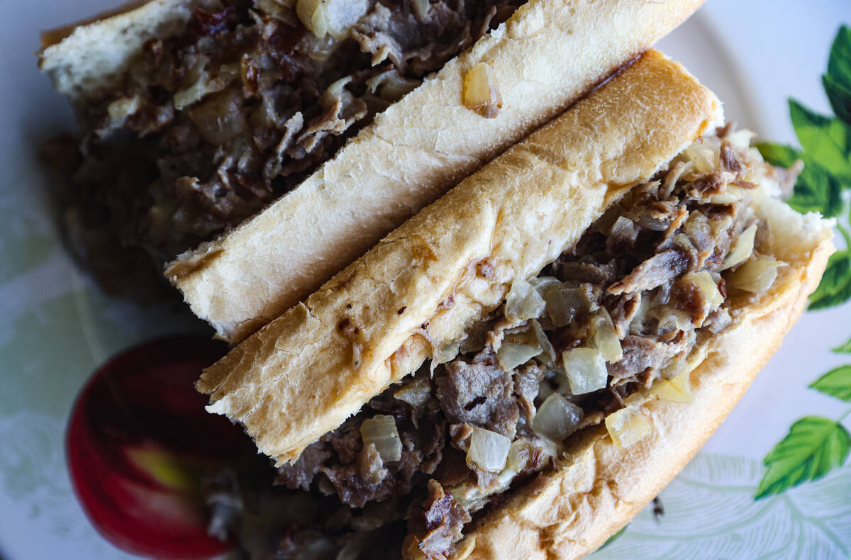 The Classic Philly Cheesesteak Sandwich on a Liscio's roll tossed with chopped fried onion and ...