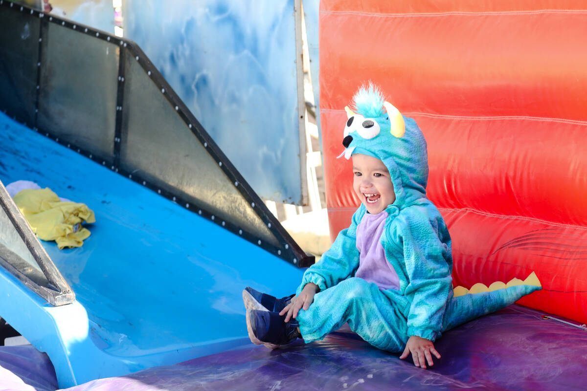 JJ Lozada, 2, laughs after going down a slide at Halloween Town Pumpkin Patch in Las Vegas, Sun ...