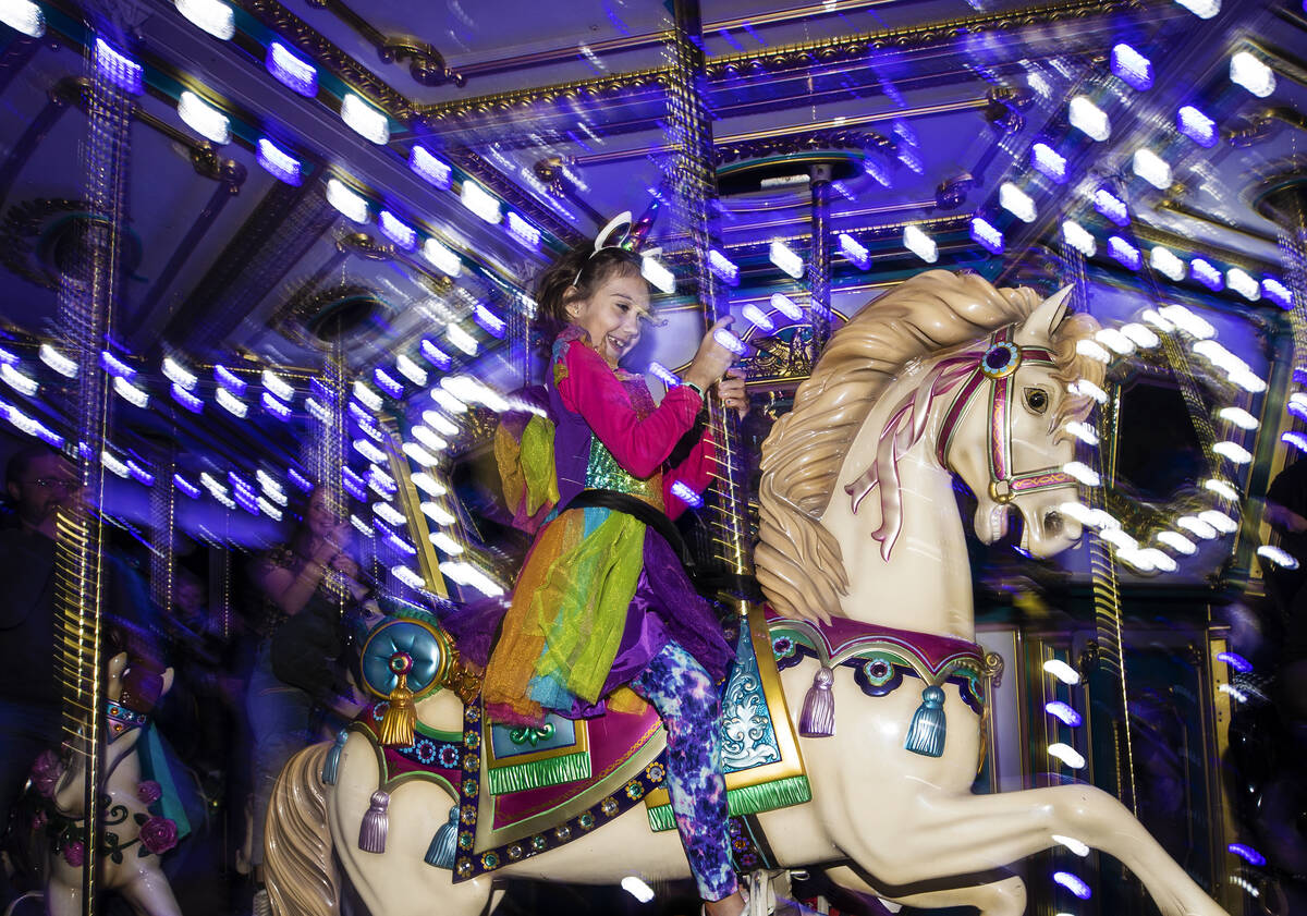 Ryah Huber, 8, rides the carousel on Saturday, Oct. 30, 2021, at Opportunity Village, in Las Ve ...