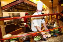 Sous Chef Tanner Gross puts out vegetables for guests to choose from at the Mongolian Grill at ...