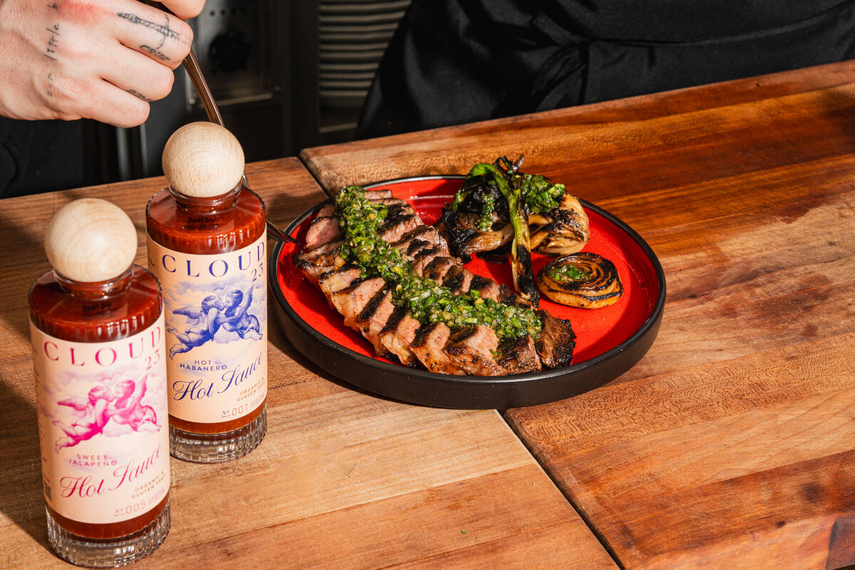 A New York strip steak marinated in Cloud 23 Hot Sauce, a limited-time dish from Komodo in the ...