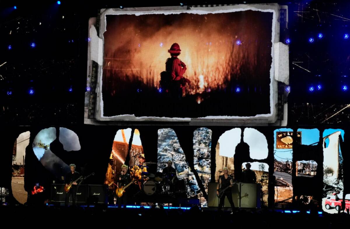 Billie Joe Armstrong, from left, Tre Cool, and Mike Dirnt of Green Day perform during the FireA ...