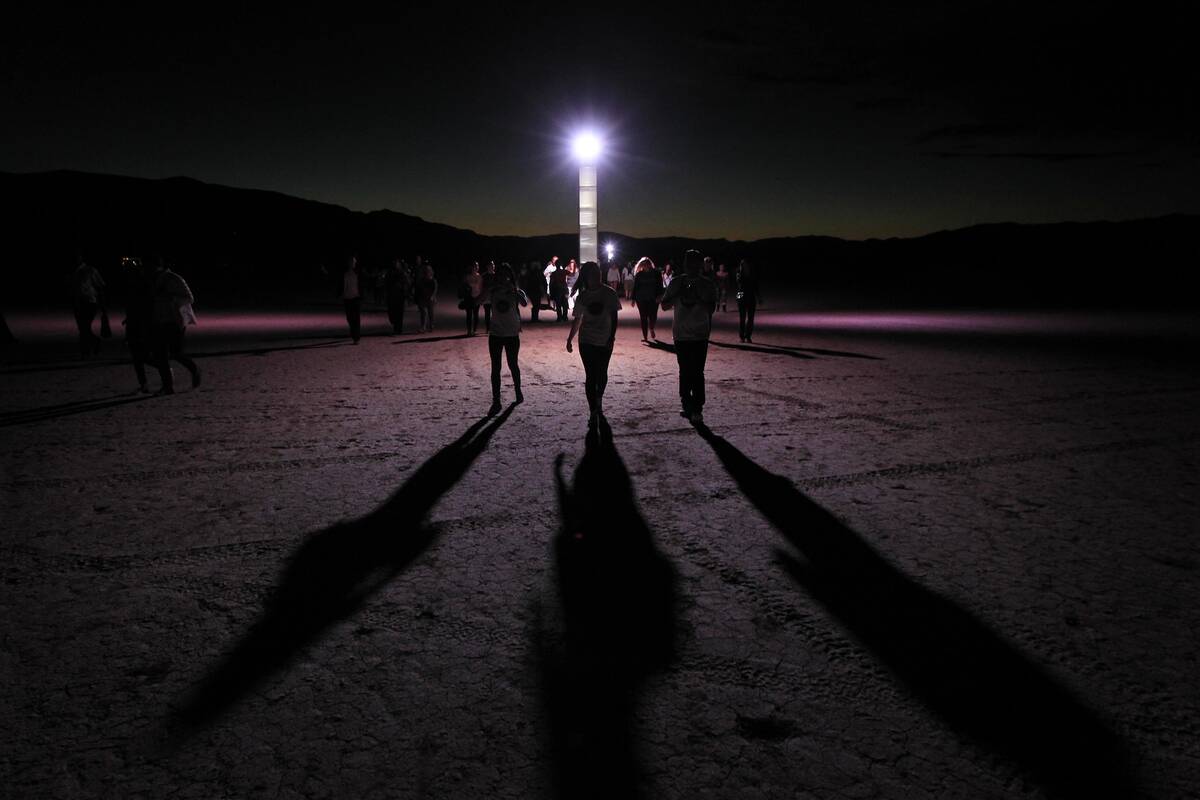 Participants make their way to the RiSE Festival Saturday, Oct. 18, 2014 on a dry lake bed near ...