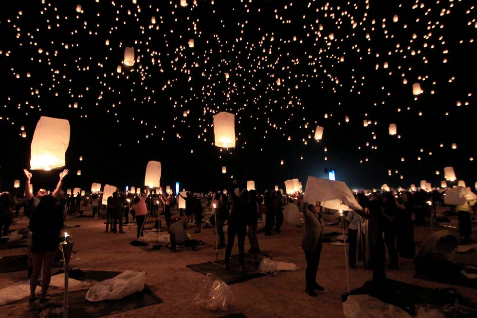 Paper lanterns are released and float to the sky at the RiSE Festival Saturday, Oct. 18, 2014 o ...