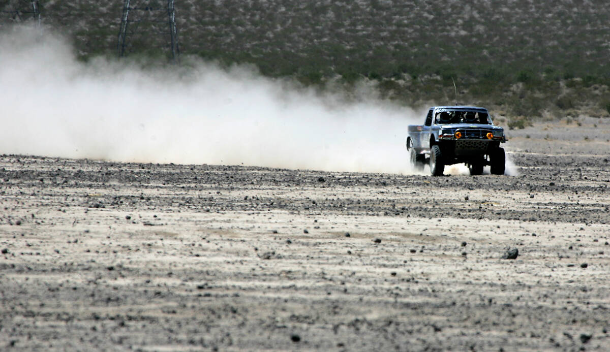 An off roader churns up a trail of dust on the dry lake bed in Eldorado Valley Friday May 25, 2 ...