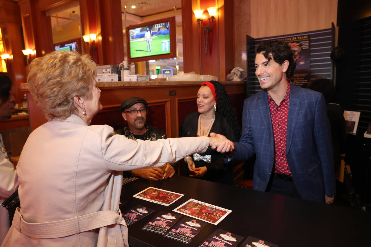 Jonathan Karrant visits with an audience member after performing in "The Dennis Bono Show" at t ...