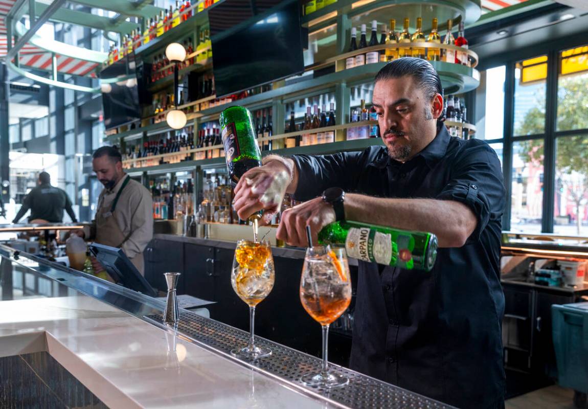 Assistant beverage manager Adrian Vera mixes cocktails at Eataly Bar in Eataly at the Park MGM ...
