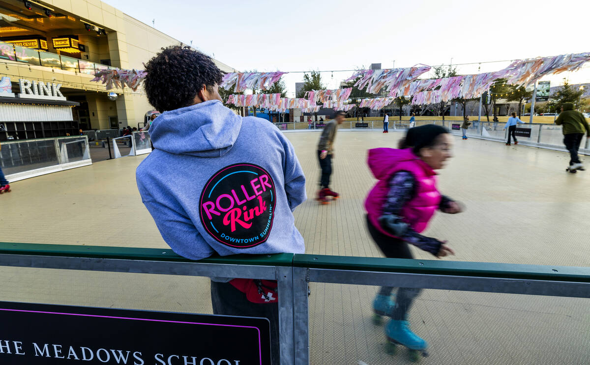 An attendant watches as skaters move about the Roller Rink Roller Rink at Downtown Summerlin pr ...
