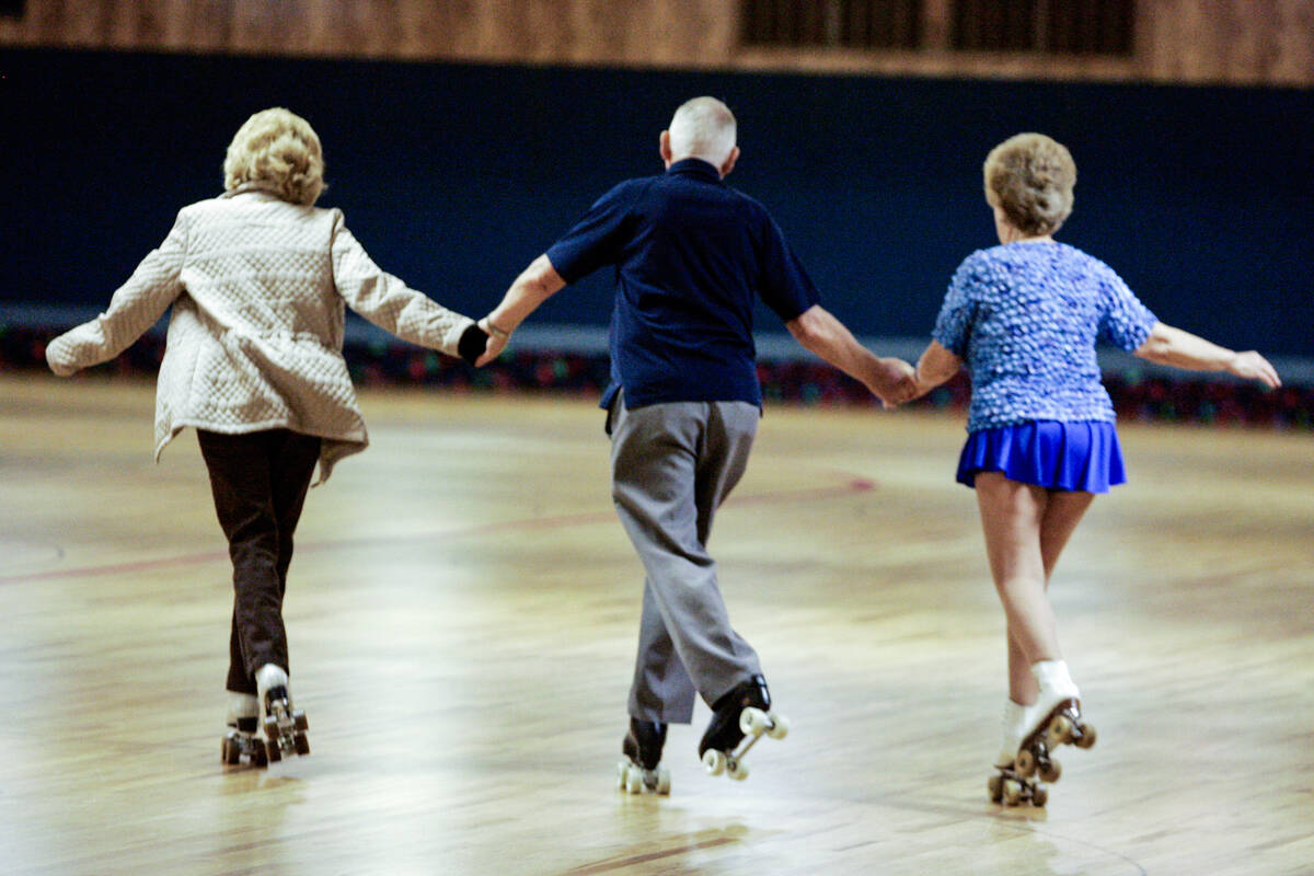 From left, Marsha Eiman, 75, Tom Burch, 78, and Pat Finnegan Keller, 70, skate hand-in-hand dur ...