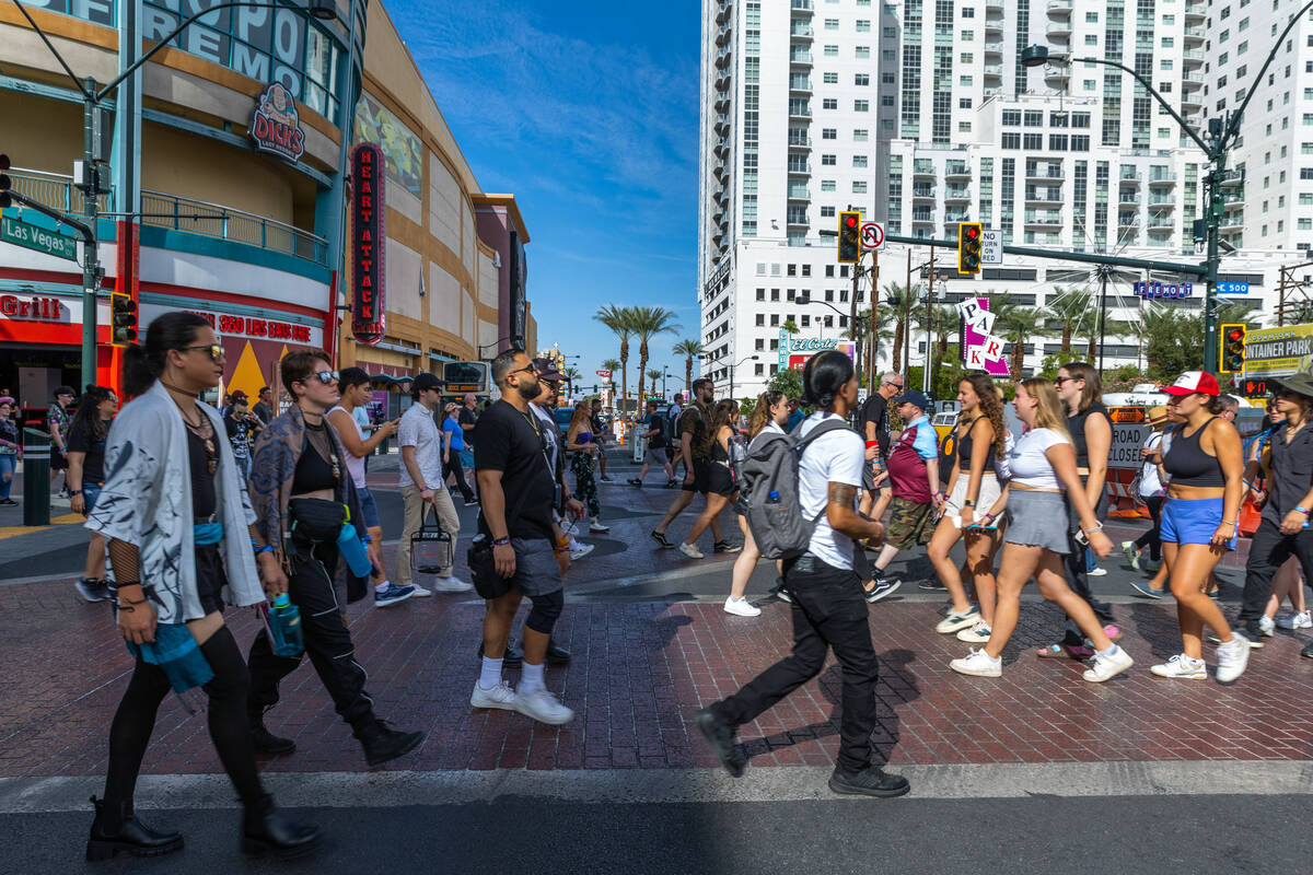 A crowd makes its way about the Fremont Street Experience, many on their way to the first night ...