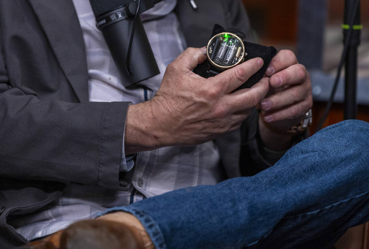 Rick Harrison holds a FALLOUTFITTERS watch given to him by guest former UFC champ Chuck Liddell ...