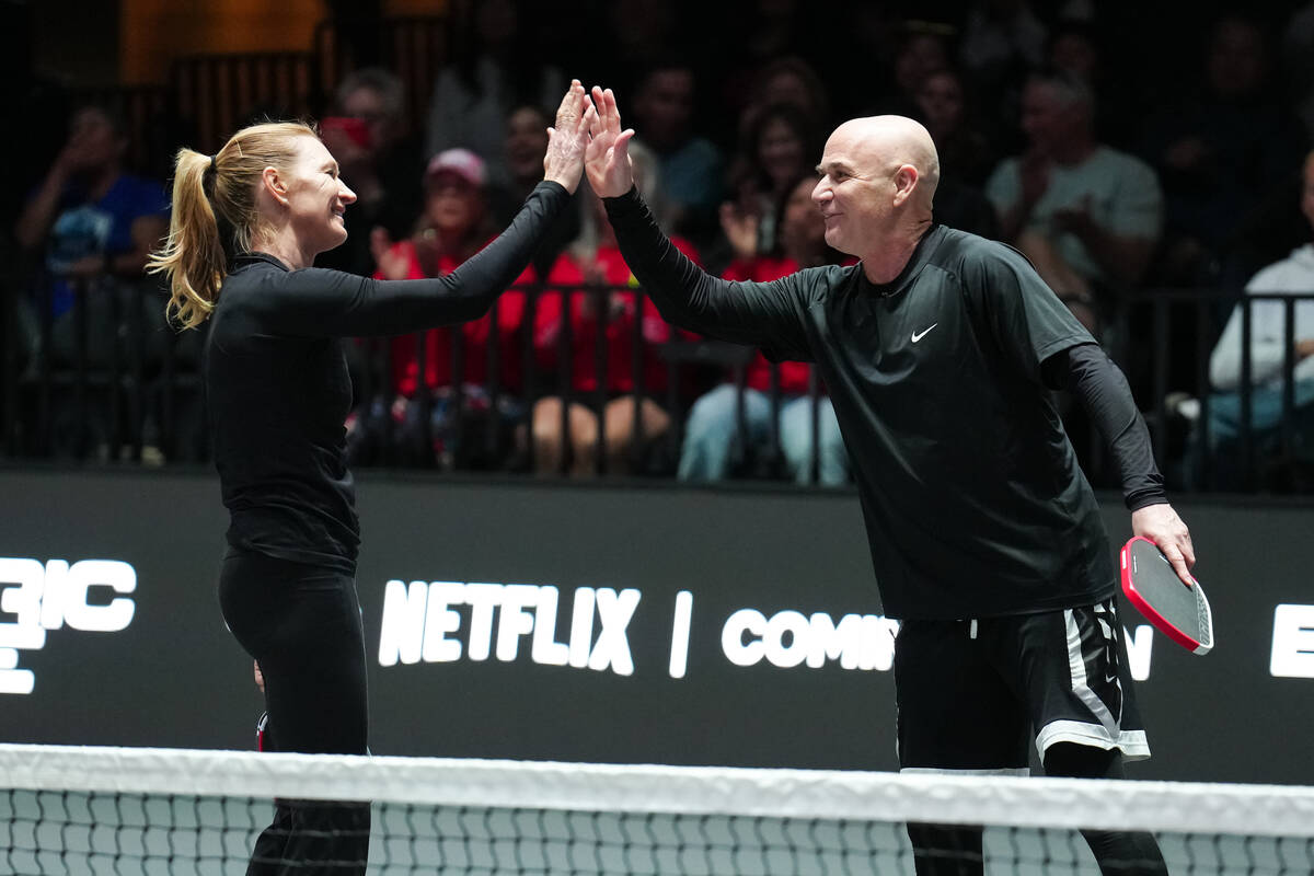 Andre Agassi and Steffi Graf celebrate winning a point at Pickleball Slam 3 at Michelob Ultra A ...