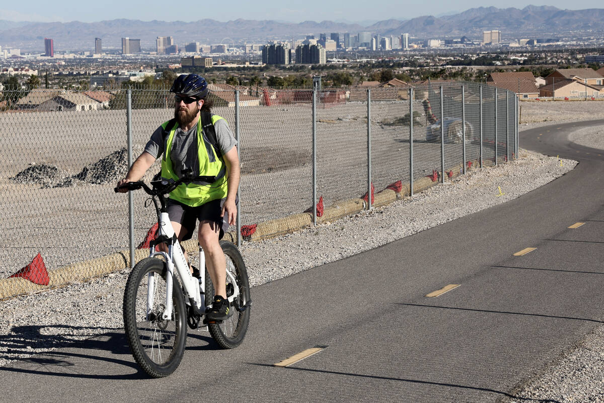 A cyclist rides an e-bike on the I-215 West Beltway Trail near Summerlin Parkway in Las Vegas T ...