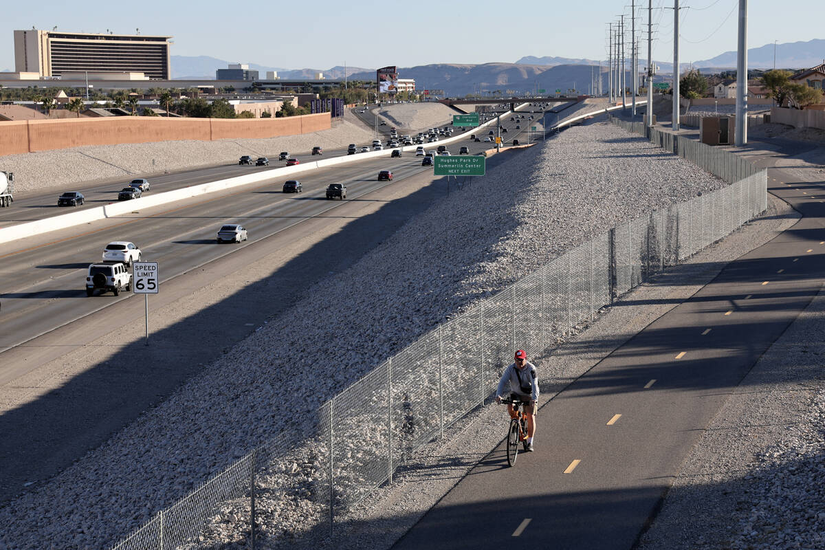 A cyclist rides on the I-215 West Beltway Trail near Alta Drive in Las Vegas Tuesday, Feb. 25, ...