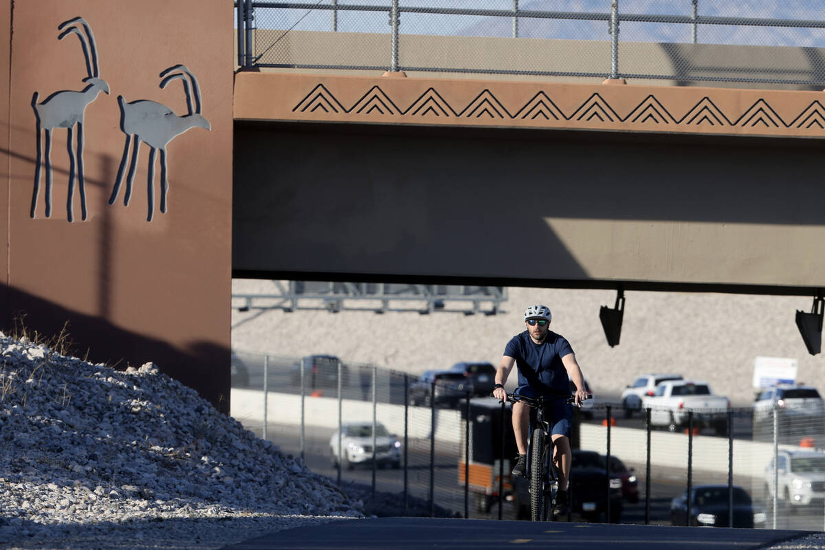 A cyclist rides on the I-215 West Beltway Trail near Alta Drive in Las Vegas Tuesday, Feb. 25, ...