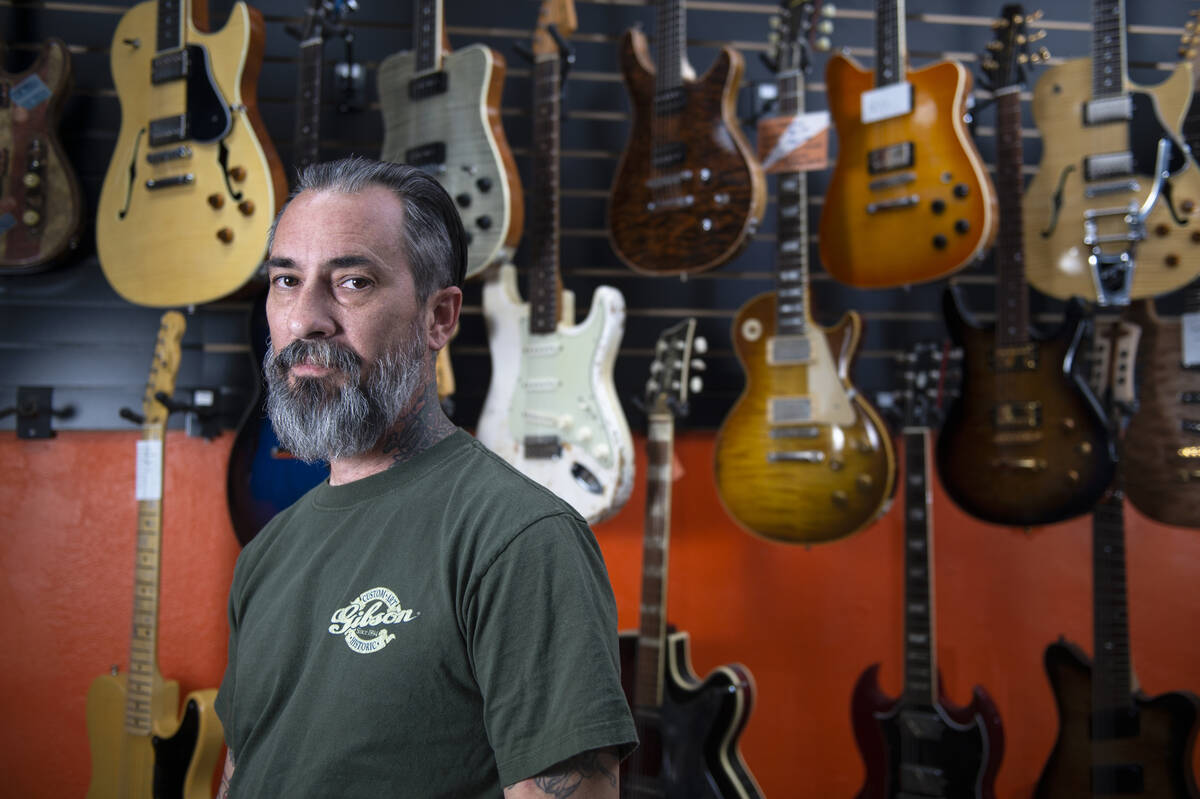 Jesse Amoroso, guitar expert and owner of Cowtown Guitars, poses for a portrait inside of his s ...