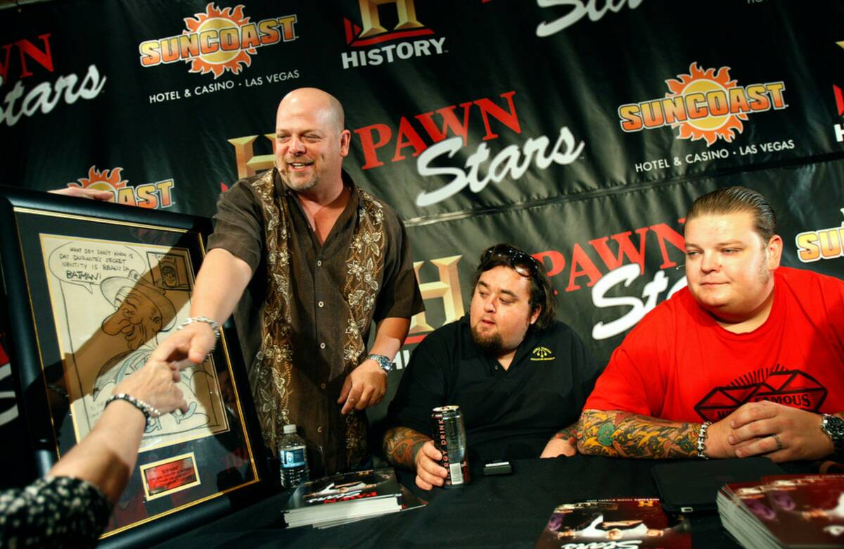 From left, Rick Harrison, Austin “Chumlee” Russell and Corey Harrison help a custom ...